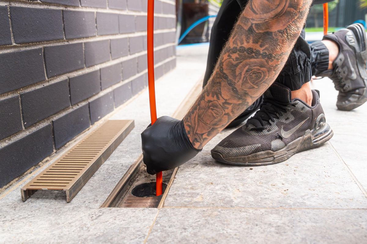 Help Plumbing tradesman clearing a blocked drain on a Sydney job